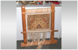 Small Persian Carpet, fixed to a wooden loom frame. Showing the technique of carpet making. 36''