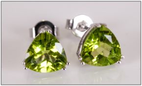 Pair of Peridot Stud Earrings, a total of 3.5cts of the vivid green gemstone, trillian cut and set