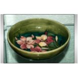 William Moorcroft Signed Footed Bowl ' Orchids ' Pattern on Green Ground. c.1930's. 8.75 Inches