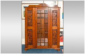 A Late Victorian Carved Oak Glazed Front Bookcase. The Single Glazed Door Front with Geometric