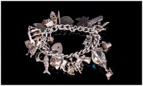 A Vintage and Heavy Silver Charm Bracelet, Loaded with 27 Charms, All of Good Quality and