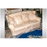 Tretrad Three Seater Sofa covered in a cream floral fabric, with loose cushion back & seats. Four