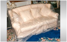 Tretrad Three Seater Sofa covered in a cream floral fabric, with loose cushion back & seats. Four