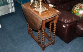 Small Sized Oak Edwardian Drop Leaf Table with barley twist legs, supported by a stretcher with oval