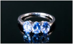 Tanzanite Trilogy Ring, three oval cut tanzanites totalling 1.75cts, set in a row in 9ct white gold;