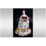 European Porcelain Figurine of a Lady Reading a Music Sheet. Dressed In 19th Century Dress, Unmarked