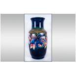 W. Moorcroft Tall Vase ' Orchids ' Design on Blue/Green Ground. Label to Underside Reads Potters