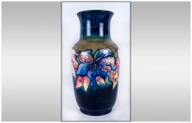 W. Moorcroft Tall Vase ' Orchids ' Design on Blue/Green Ground. Label to Underside Reads Potters