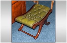 A Green Button Back Leather Saddle Back Stool, In Mahogany, On Shaped Legs with Cross Stretcher.
