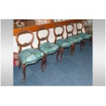 A Set of Five Victorian Carved Walnut Balloon Back Chairs with carving to the top and central bar.