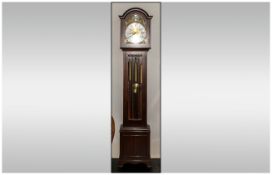 Reproduction Arched Brass Dial Glazed Front Grandfather Clock in mahogany case, with 3 exposed