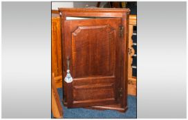 An Antique Georgian Single Door Corner Cupboard of Small Size with a Shaped Chamford Door Panel with