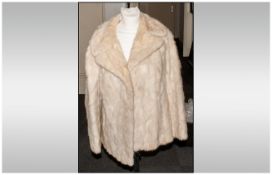 Ladies Blonde Mink Jacket fully lined. Half back belt. Collar with revers, slit pockets. Approximate