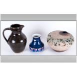 Three Art Pottery Vessels comprising one brown glazed jug, stamped Wales, blue abstract vase,