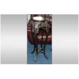A Chinese Carved Cherry Wood Urn Stand. The Top With a Rouge Coloured Marble Insert. Supported on