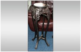 A Chinese Carved Cherry Wood Urn Stand. The Top With a Rouge Coloured Marble Insert. Supported on