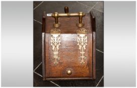 A Late Victorian Oak Lift Up Front Coal Skuttle with a tin liner and brass carrying handle and large