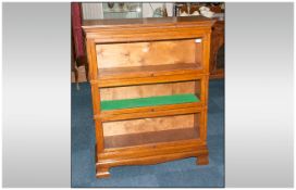 Three Tier Simpoles Of London Oak Stacking Bookcase with glazed sliding doors. On shaped bracket