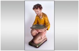 A 1930'S Chalk Decorated Figure of A Kneeling Boy holding a tray, 18 inches high.