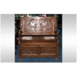 A Profusely Carved Oak Monks Bench, with a Fold Down Table Top. Fully Carved. With a Lift up Bench