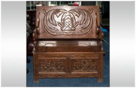 A Profusely Carved Oak Monks Bench, with a Fold Down Table Top. Fully Carved. With a Lift up Bench