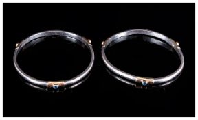 A Vintage Pair of Silver and Gilt Bangles - Set with Blue Sapphires In Gilt Mounts. Not Marked but