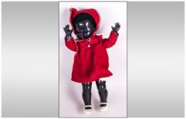 Pedigree Black Doll, black plastic body with moveable limbs and  glass eyes with eye lashes. Dressed