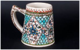 Isnik Pottery Tankard With Handle decorated in coloured glazes of flowers & decorative borders.