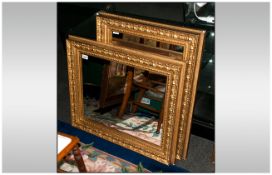 Pair of Gilt Framed Mirrors with Moulded Decorations and Swept Frames. Size 23 x 28 Inches.