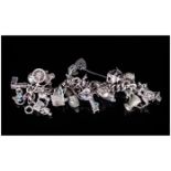 A Vintage and Heavy Silver Curb Bracelet, Loaded with 28 Silver Charms of Various Subjects and