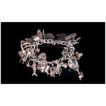 A Vintage and Heavy Silver Charm Bracelet, Loaded with 27 Charms, All of Good Quality and