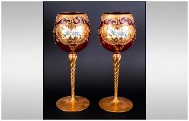 Pair Of Ruby Glass Murano Hock Glasses decorated in thick gold leaf with coloured enamel flowers.