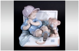 Lladro Figure 'My Favourite Place' boy & teddy in suitcase. Model number 67958, sculpture Joan