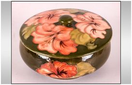 Moorcroft Lidded Powder Bowl ' Coral Hibiscus ' Design on Green Ground. 3.25 Inches High, 5.5 Inches