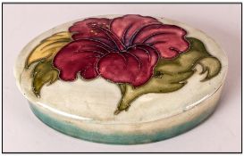 Moorcroft Oval Shaped Lidded Trinket Box / Jar ' Hibiscus ' Design. Pale on Green Ground. 5 Inches