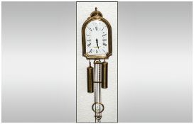 A Reproduction Brass Wall Clock with enamel dial. Maker Dupont A St Denis.