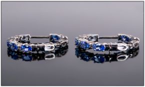 Tanzanite and White Topaz Hoop Earrings, oval cut tanzanites interspaced with small white topaz to