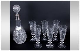 Glass Decanter with silver plated rim and star cut base. Together with set of 6 champagne flutes.