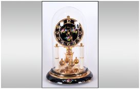 German 300 Day Revolving Ball Pendulum By Kan with a floral painted black dial on supporting