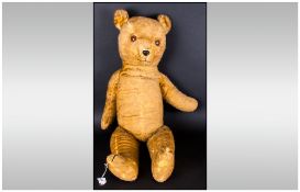 Vintage Plush Teddy Bear Of Large Size with glass eyes. well loved/worn condition. 31'' in length.
