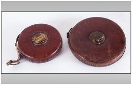 Two Leather Cased Tape Measures By Chesterman, Sheffield. 6'' & 4'' in diameter.