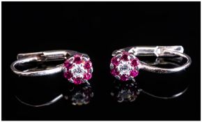 18ct White Gold Earrings, Each Set With A Central Diamond Surrounded By Rubies, Stamped 750