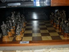 Wooden Chess Board with Medieval Figures as Chess Pieces.