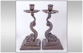 Pair of Bronze Dolphin Candlesticks, each base comprising the bewhiskered dolphin head resting on