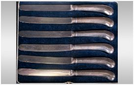 Set Of Six Pistol Grip Silver Handled Fruit Knives, fitted in black leather case.