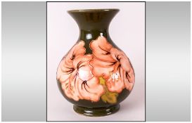 Moorcroft Globular Shaped Vase ' Coral Hibiscus ' Design on Green Ground. Label to Base Reads -