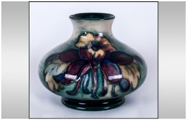 Moorcroft Squat Vase 'Columbine' Design On Green Ground. 3'' in height, Chip to rim.