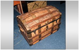 Antique Leather Clad Domed Top Travelling Trunk, with wood strapping to the top and sides with