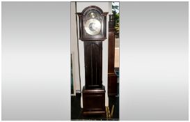 Brass Faced Grandmother Clock in a Mahogany case with a glazed door, exposing three brass