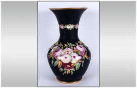 A Victorian Pottery Decorated Vase with a black body decorated with pink and various coloured roses.